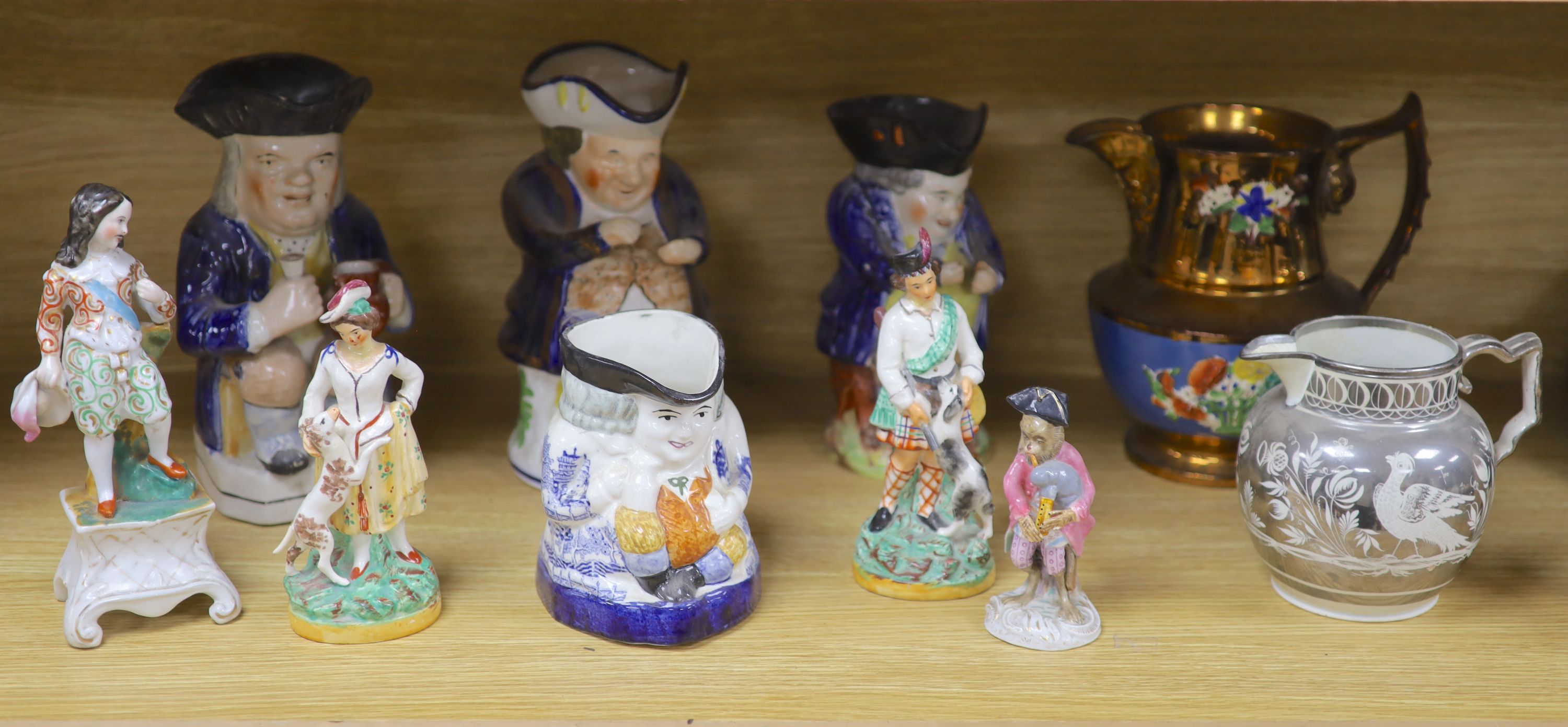 A quantity of Staffordshire pottery, including four Toby jugs, four figures, a copper lustre jug and a silver resist jug (10)